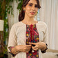 White and black striped dress with Kalamkari panel and tie-up neckline.