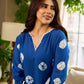 Refreshing cobalt blue shibori tie-dye dress with ivory accents and delicate lace-trimmed neckline.