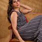 Textured grey Jamdani sleeveless waistcoat with bold red accents and an asymmetrical opening, creating a sharp, modern silhouette with distinctive, fashion-forward appeal.