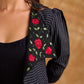 Exquisite black Ikat jacket with offset collar flaps and detailed red floral vine embroidery, delivering a sculpted, high-impact silhouette with refined presence for corporate styling.
