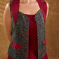 Sharp dark teal and maroon checkered sleeveless jacket with a distinctive notch collar and princess-cut tailoring, offering a structured silhouette ideal for elevated corporate styling.