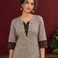 Elegant Beige Ajrakh Striped Cotton Kurta with Contrast Black Floral patch in Neckline & Sleeve Cuffs — styled view