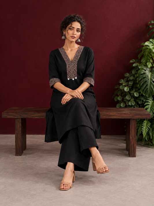 Timeless Black Cotton Kurta with Contrast Beige Ajrakh Printed V-Neck Panel & Matching Sleeve Cuffs — seated