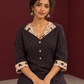 Black Polka Dot Kurta with Ajrakh Printed Beige Collar and Contrast Cuffs — seated detail