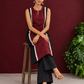 Classic Black Cotton Kurta with Maroon Polka Dot Triangle Panel & Crochet Lace Trim — seated