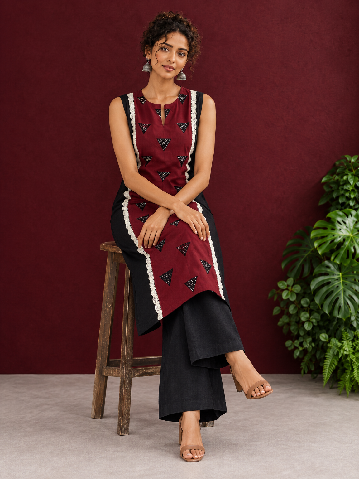 Classic Black Cotton Kurta with Maroon Polka Dot Triangle Panel & Crochet Lace Trim — seated
