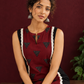 Classic Black Cotton Kurta with Maroon Polka Dot Triangle Panel & Crochet Lace Trim — seated detail