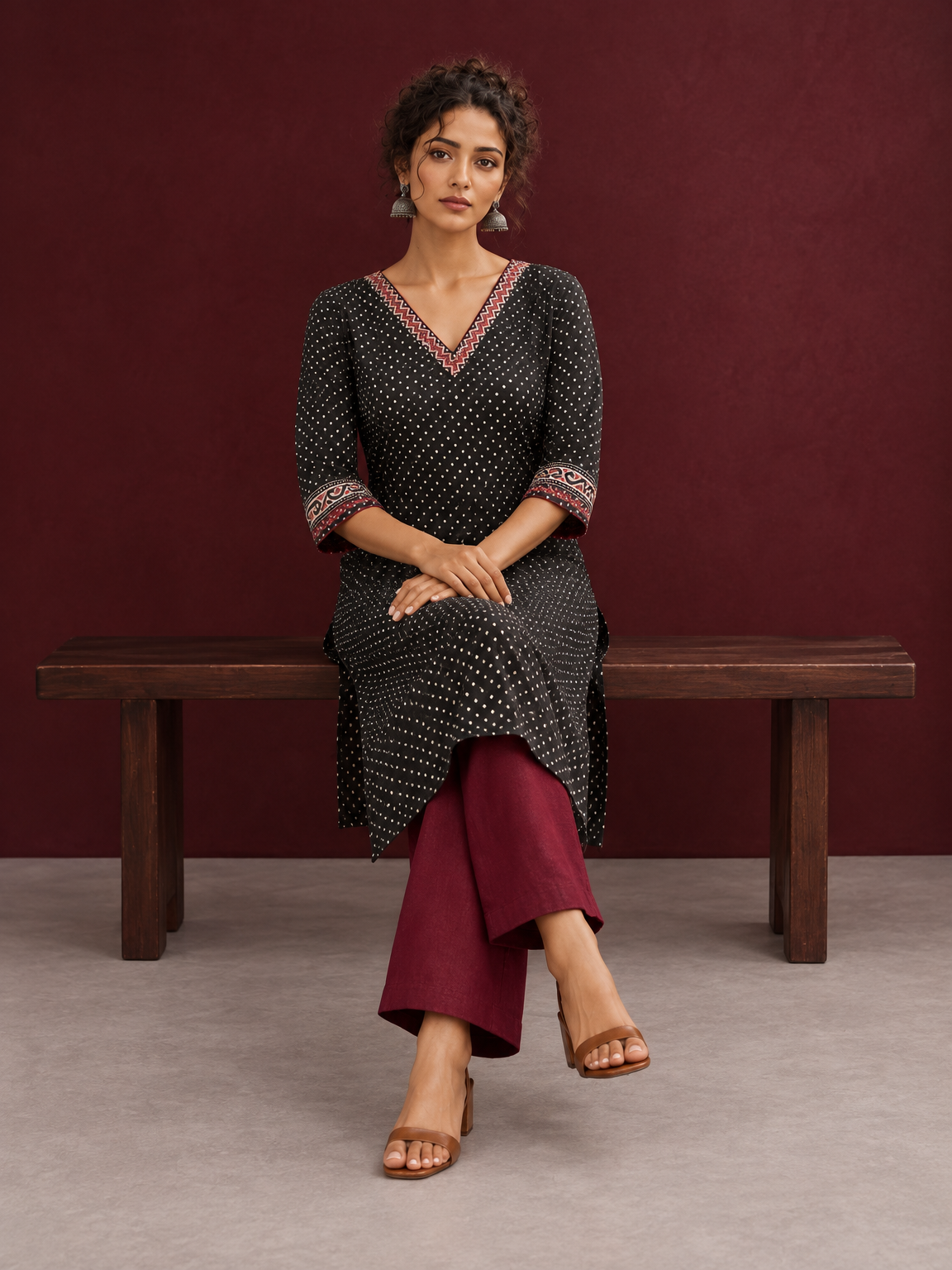 Classic Black Polka Dot Kurta with Contrast Zig-Zag Ajrakh V-Neck With Ajrakh Border On Cuffs — seated