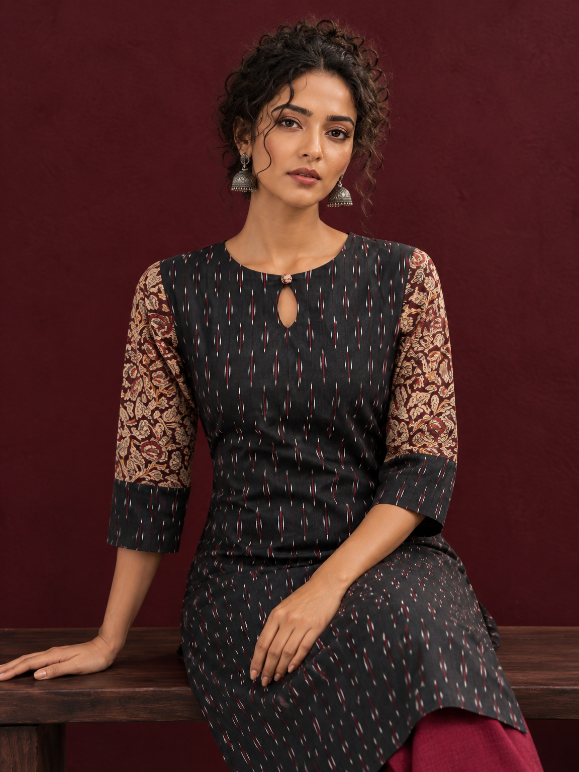 Timeless Black Ikat Cotton Kurta with Contrast Kalamkari Print Sleeves & Keyhole Neckline — seated detail