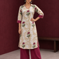 Ivory floral printed kurta with pink and green flowers, a V-neck, and contrasting pink cuffs. — front view