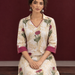Ivory floral printed kurta with pink and green flowers, a V-neck, and contrasting pink cuffs. — seated detail