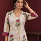 Ivory floral printed kurta with pink and green flowers, a V-neck, and contrasting pink cuffs. — styled view