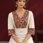 Elegant Off-White Cotton Kurta with Kalamkari Leaf Print Yoke and Contrast Cuffs — seated detail
