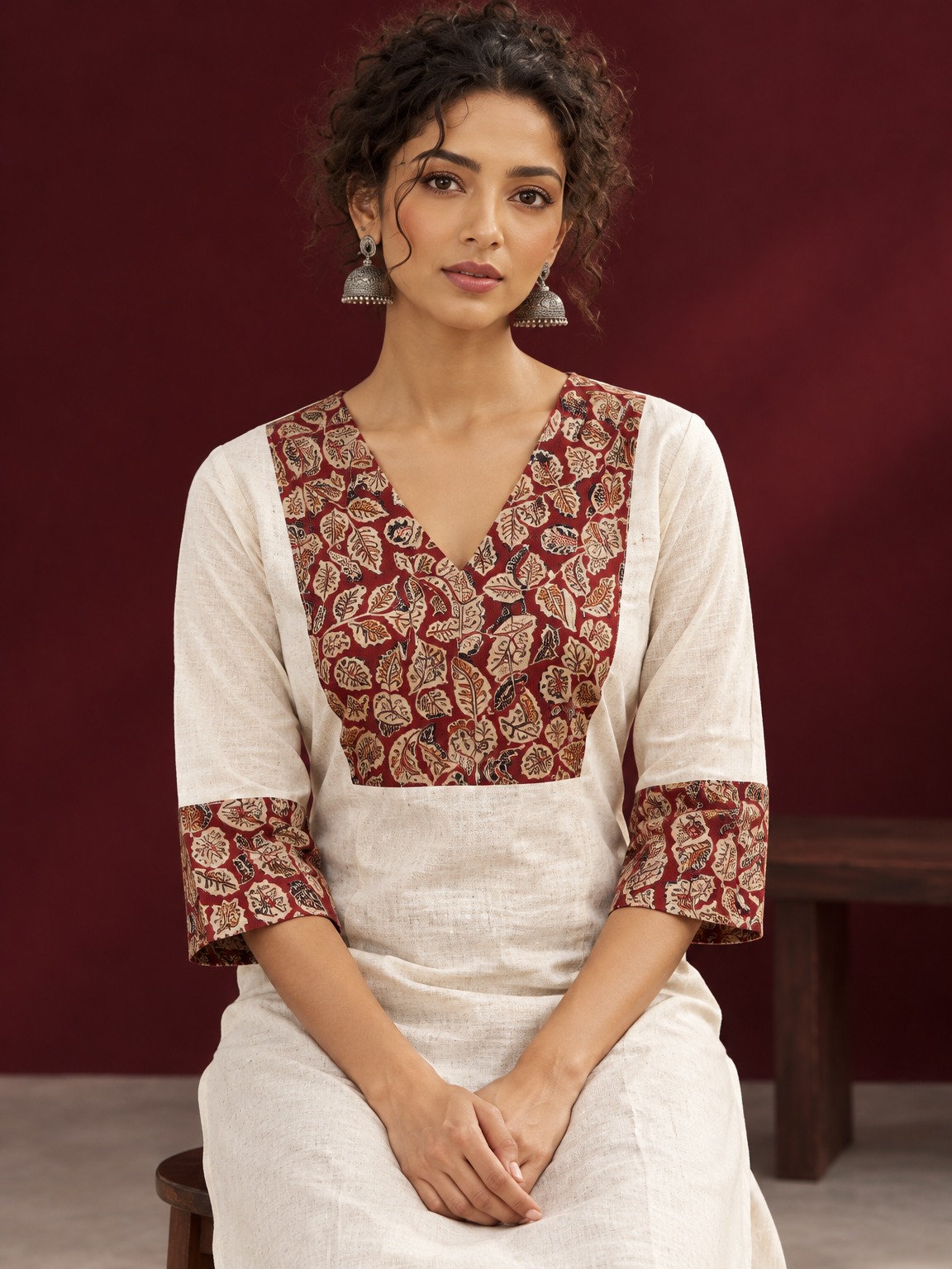 Elegant Off-White Cotton Kurta with Kalamkari Leaf Print Yoke and Contrast Cuffs — seated detail