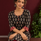 Elegant Black Cotton Ajrakh Kurta with Maroon Contrast Piping, Buttons & Ajrakh Floral Motif Print — seated detail