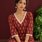 Maroon Cotton Ajrakh Kurta with Floral Motif Block Print and Crochet Lace V-Neck & Sleeve Cuffs — seated detail