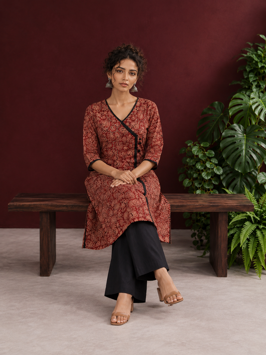 Maroon Cotton Kurta with Ajrakh Floral Print, Black Contrast Binding & Angrakha Style Wrap Front — seated