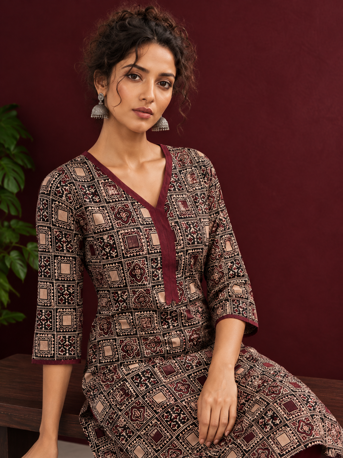 Timeless Black Ajrakh Print Cotton Kurta with Maroon V-Neck — seated detail
