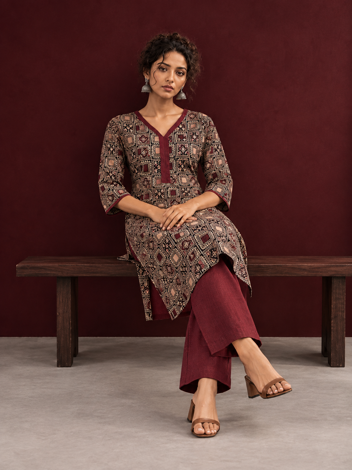 Timeless Black Ajrakh Print Cotton Kurta with Maroon V-Neck — seated