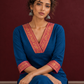 Elegant Peacock Blue Cotton Kurta with Contrast Pink & Gold Woven Border Neckline and Matching Salwar — seated detail