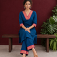 Elegant Peacock Blue Cotton Kurta with Contrast Pink & Gold Woven Border Neckline and Matching Salwar — seated