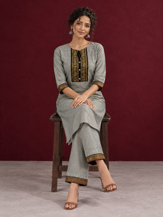 Elegant Sage Green Silk Kurta with Black zari Paisley Yoke & Contrast Sleeve Cuffs — seated