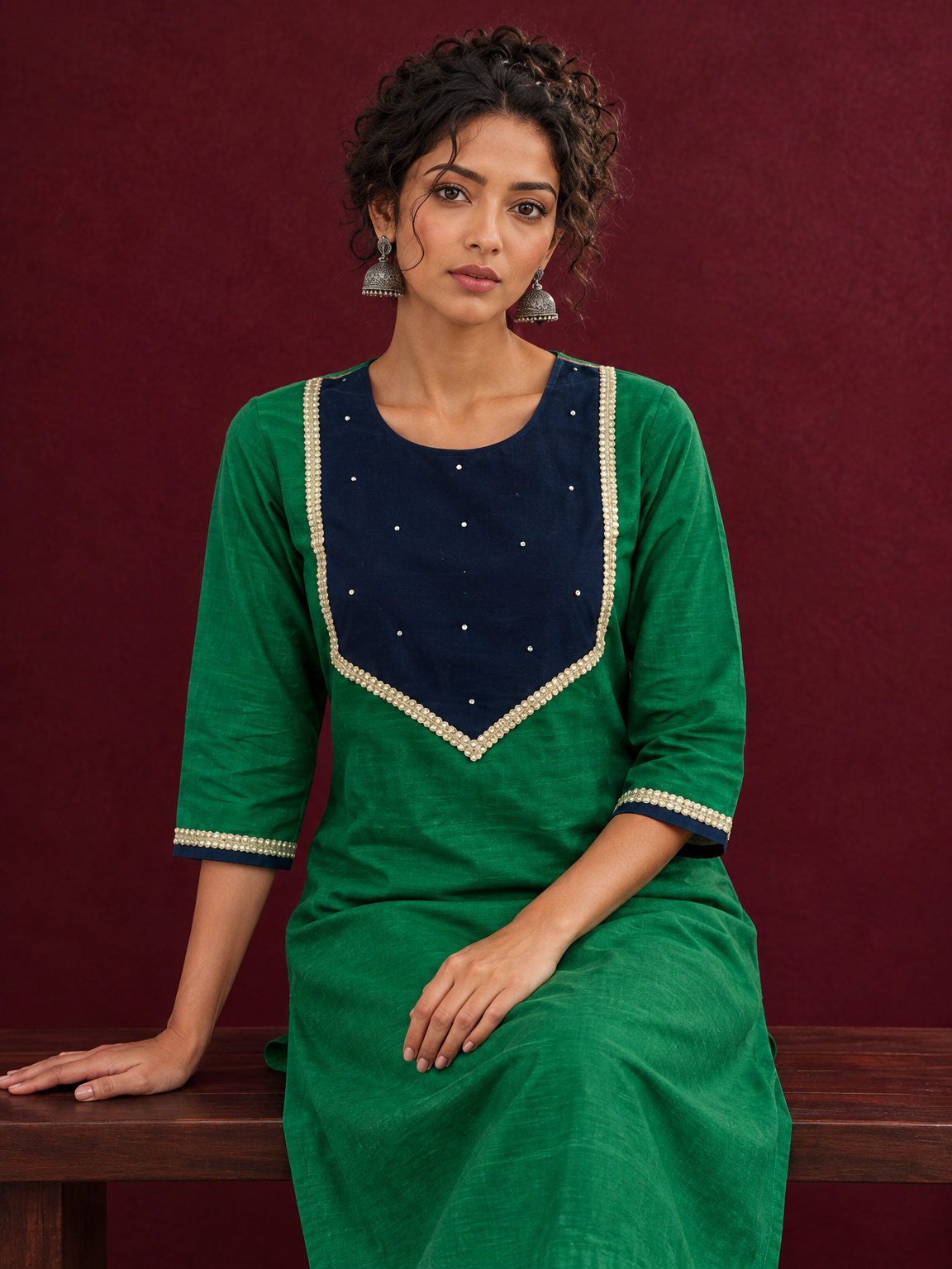 Elegant Green Silk Kurta with Contrast Navy Blue Yoke Panel, Sequin Embellishment & Gota Trim — seated detail