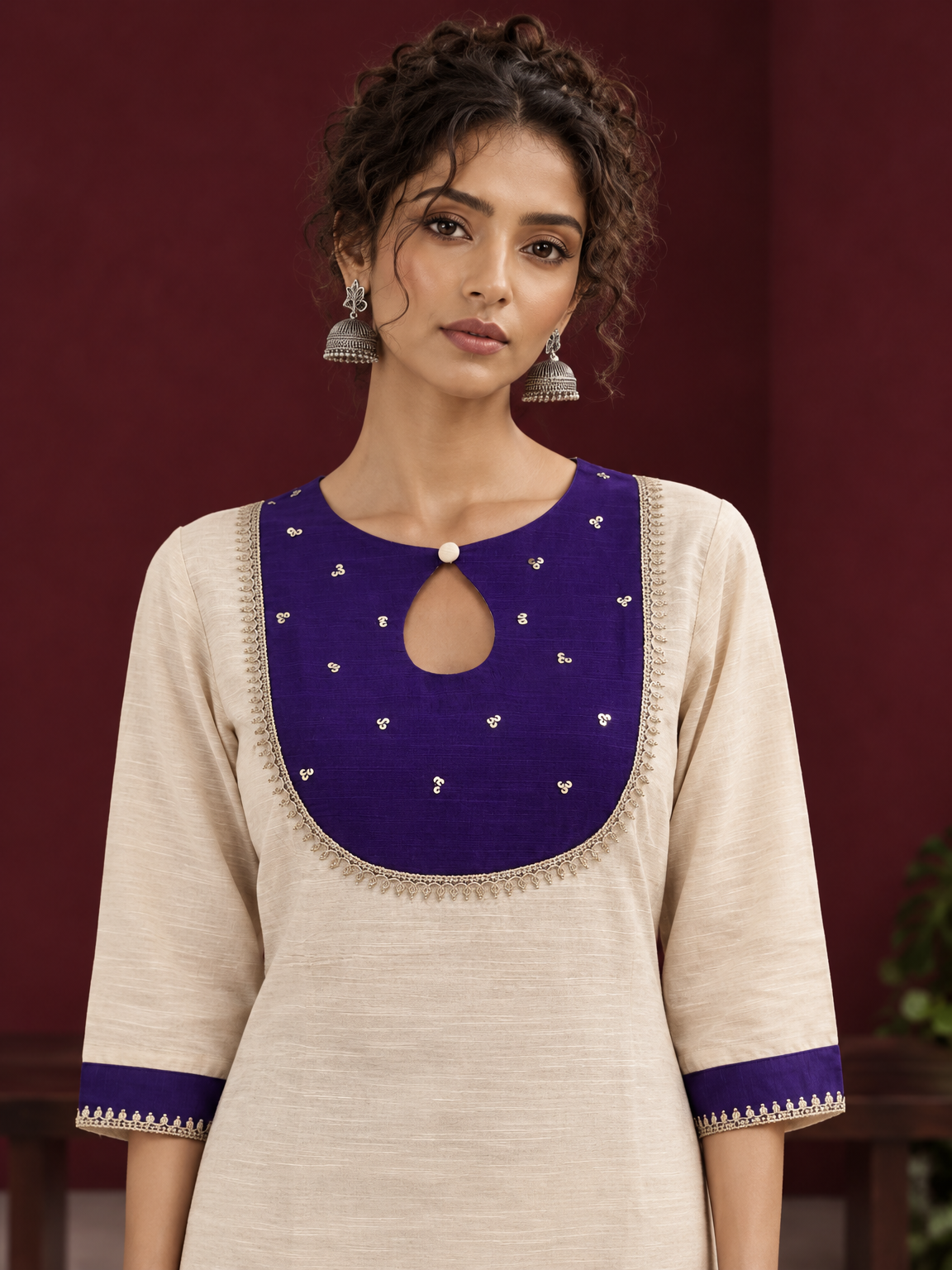 Elegant Off-White Silk Kurta with Contrast Purple Yoke Panel & Hand Embroidered Sequin Detailing — fabric detail
