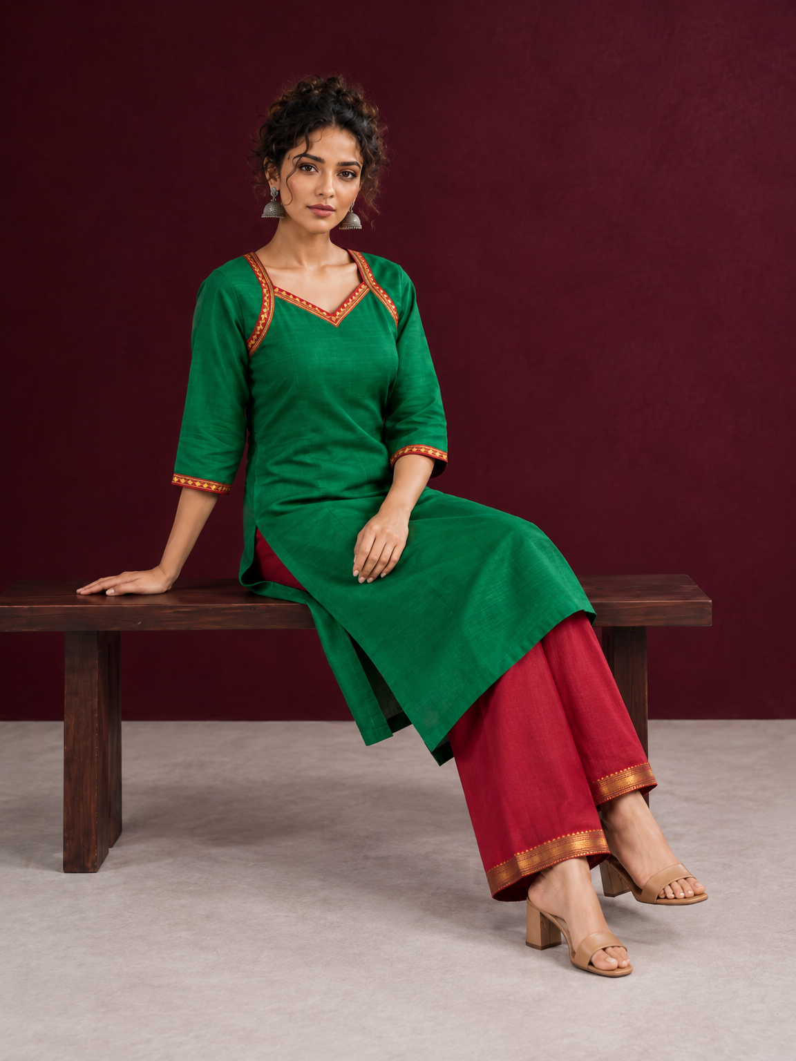 Vibrant Green Silk Kurta with Contrast Maroon Traditional Lace On Neckline — seated