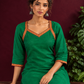 Vibrant Green Silk Kurta with Contrast Maroon Traditional Lace On Neckline — seated detail