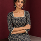 Elegant Black Printed Kurta with Beige Crochet Lace Square Neckline & Sleeves Trims — seated detail