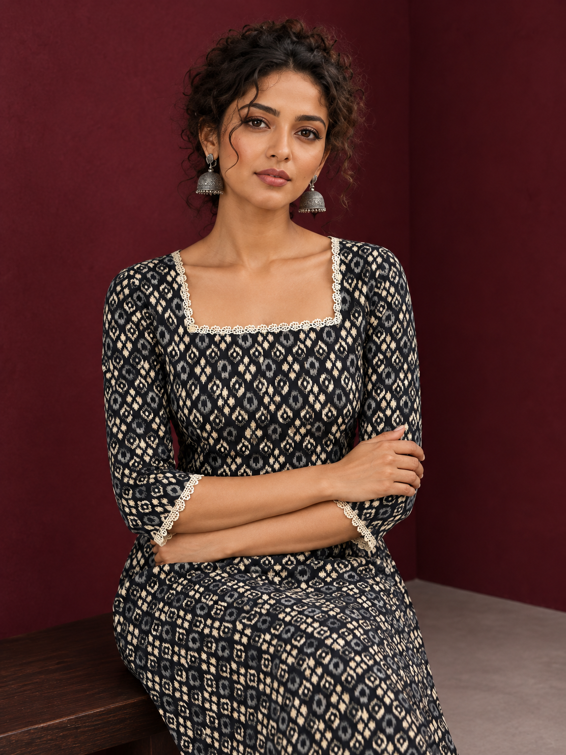 Elegant Black Printed Kurta with Beige Crochet Lace Square Neckline & Sleeves Trims — seated detail