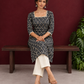 Elegant Black Printed Kurta with Beige Crochet Lace Square Neckline & Sleeves Trims — seated