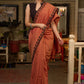 Graceful rust cotton plain saree highlighted with overall ajrakh applique border