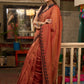 Graceful rust cotton plain saree highlighted with overall ajrakh applique border
