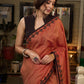 Graceful rust cotton plain saree highlighted with overall ajrakh applique border