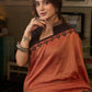 Graceful rust cotton plain saree highlighted with overall ajrakh applique border