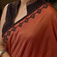 Graceful rust cotton plain saree highlighted with overall ajrakh applique border