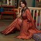 Graceful rust cotton plain saree highlighted with overall ajrakh applique border