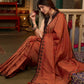 Graceful rust cotton plain saree highlighted with overall ajrakh applique border