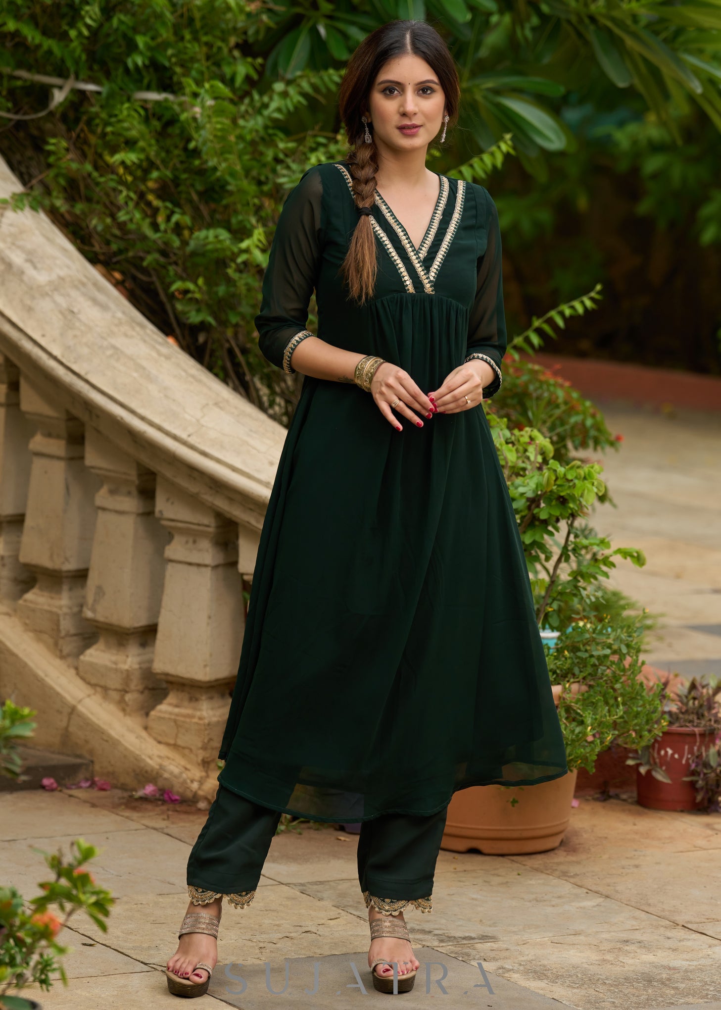 Elegance redefined in this captivating green georgette lace kurta and pant ensemble
