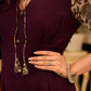 Playful purple cotton dress showcasing floral puff sleeves and box pleats released from the dart for soft volume and flow