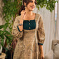Artisanal beige Madhubani dress featuring intricate motifs, a contrasting green yoke, and refined accents.