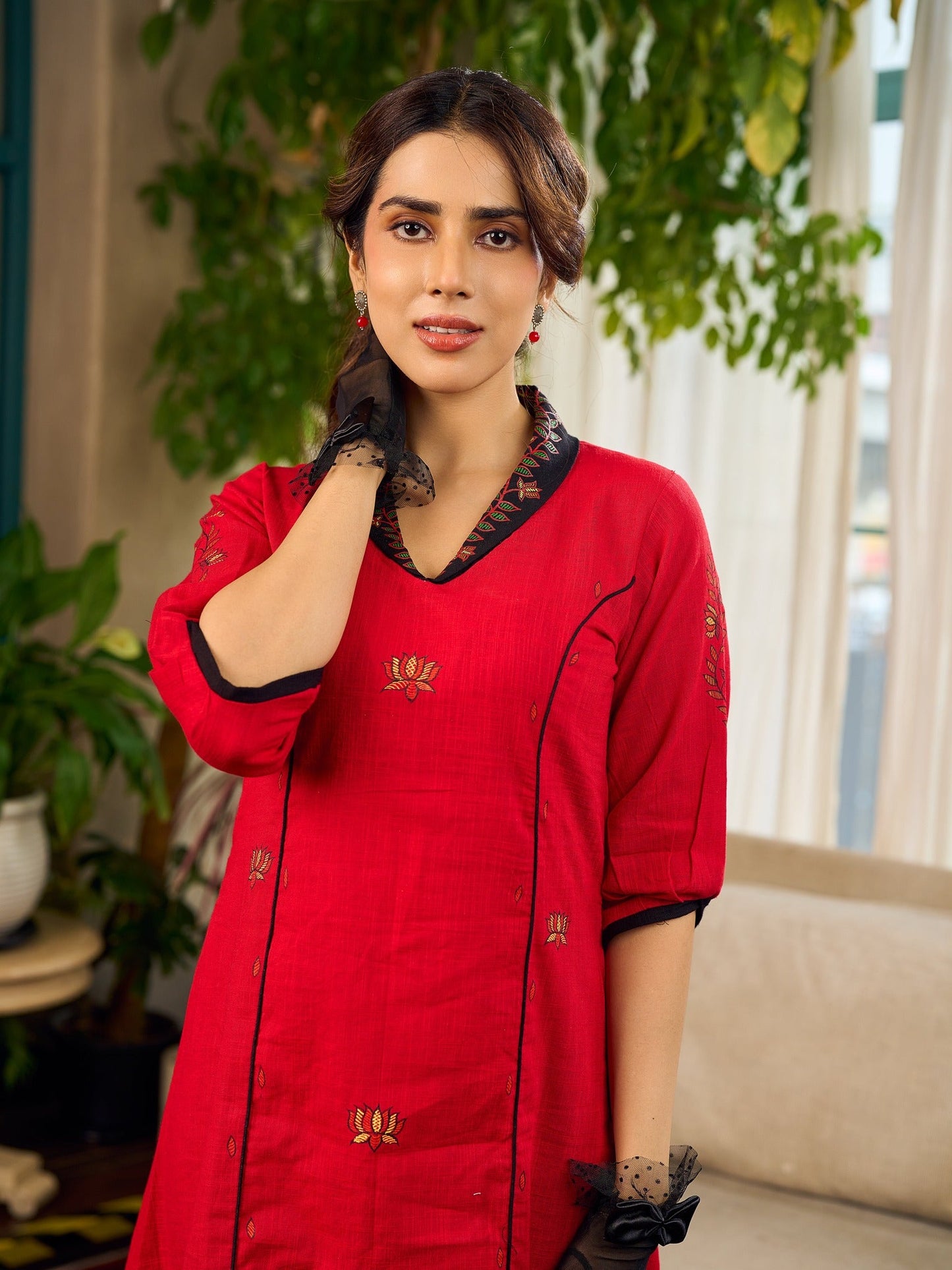 Elegant red dress featuring delicate, hand-painted Madhubani lotus motif detailing.