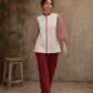 Chic off-white top featuring intricate hand block print sleeves in a vibrant red, complemented by a matching central decorative trim.