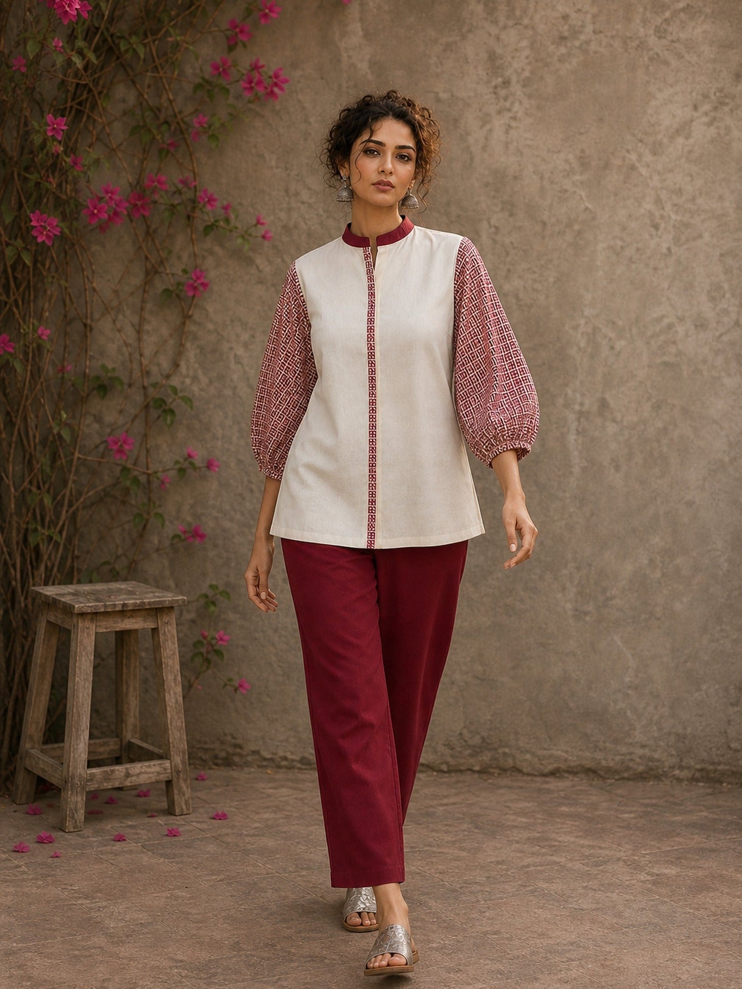 Chic off-white top featuring intricate hand block print sleeves in a vibrant red, complemented by a matching central decorative trim.