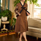 Brown block print dress with floral block printed flared sleeves, black tie-up neckline, and contrast black accents for an effortless, elegant everyday look.
