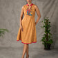 Mustard Gond printed mandarin collar dress with vibrant pink accents.