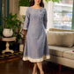 Two-tone handloom cotton dress with delicately painted Madhubani fish motifs and pleated hem.