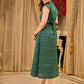 Teal Printed Sleeveless Crossover Midi Designed in a rich teal print, highlighting a crisp notched collar, defined wrap waist, and a fluid flared silhouette.